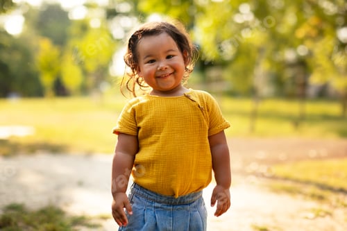 Preview: Cute Korean Toddler Baby Girl Stands Outdoors in Nature
