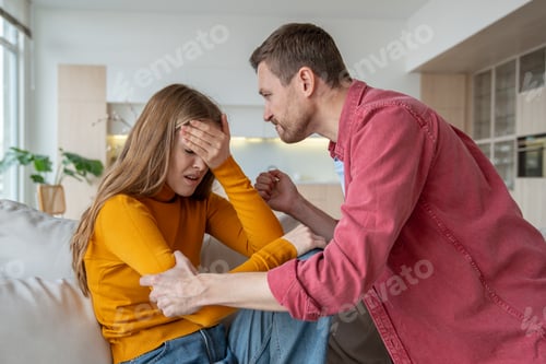 Preview: Unfaithful wife hiding face from furious husband ready to beat. Infidelity, adultery in relations