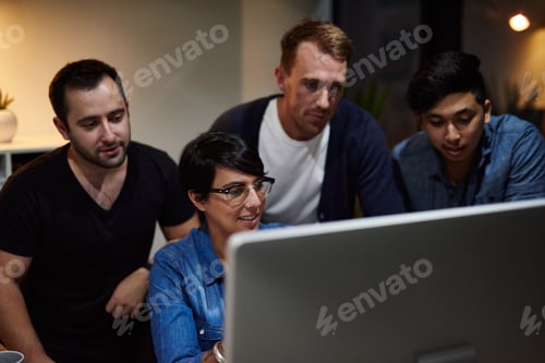 Preview: Working on their plans for success. Shot of employees working in an office at night.