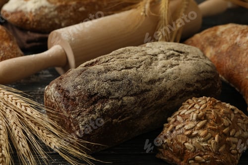 Preview: Fresh bread, spikelets and rolling pin on wooden background