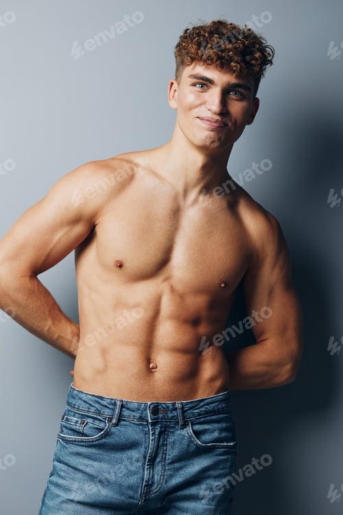 Preview: man standing handsome athlete male guy sport chest gray jeans smile person
