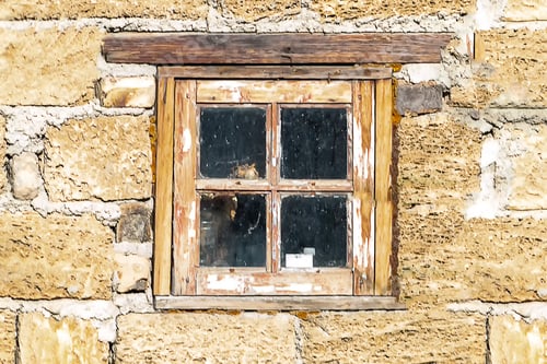 Preview: A wooden window in the wall of stone shell blocks.