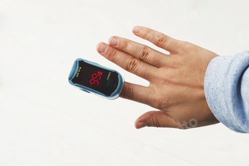 Preview: Pulse Oximeter on adult hand on white background, measuring blood oxygen level, tests saturation