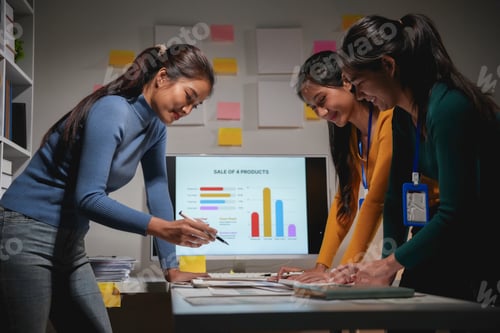 Preview: Three asian businesswomen working together in office at night