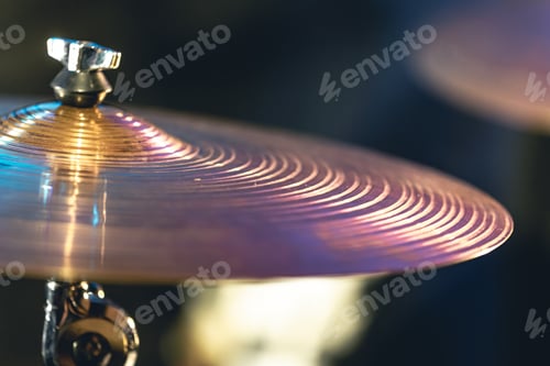 Preview: Drum cymbal close-up on a dark blurred background.