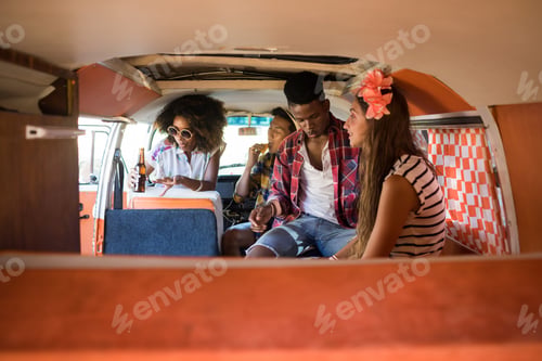 Preview: Young friends sitting in camper van