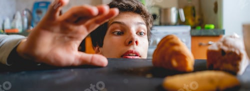 Preview: young man peeking from the table and stealing food