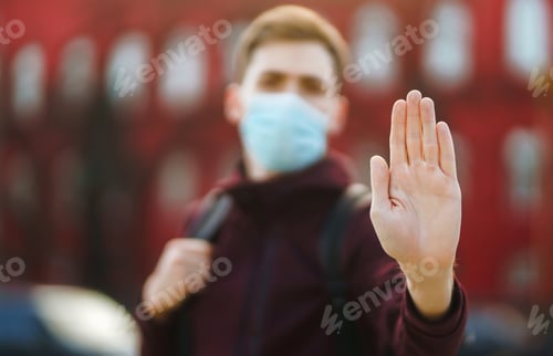 Preview: Portrait of men in protective sterile medical mask on her face on the street city. pandemic.