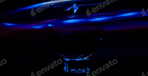 Preview: Crystal ball on a rectangular object with blue waves on black background