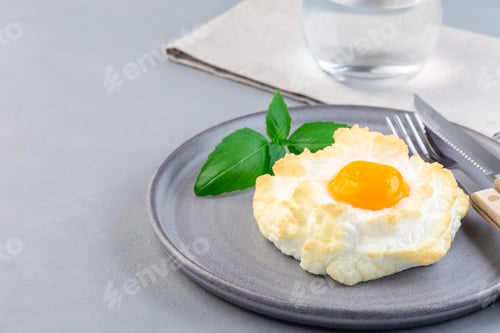 Preview: Oven baked cloud or fluffy egg dish on gray plate, horizontal, copy space