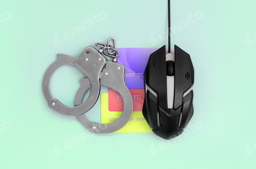 Preview: Computer mouse, credit cards and police handcuffs are on a pastel turquoise background