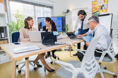 Preview: Business Professionals Discussing Project in Modern Office