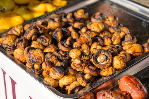 Preview: Baked grilled champignon mushrooms in a large bowl.