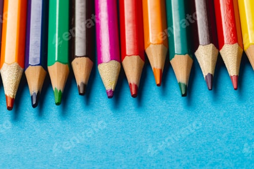 Preview: Composition of colorful crayons on blue surface with copy space
