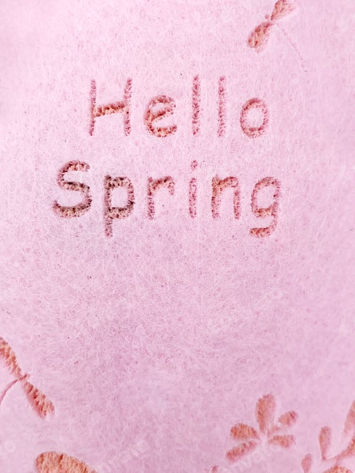 Preview: Pink Textured Surface With Phrase "Hello Spring"