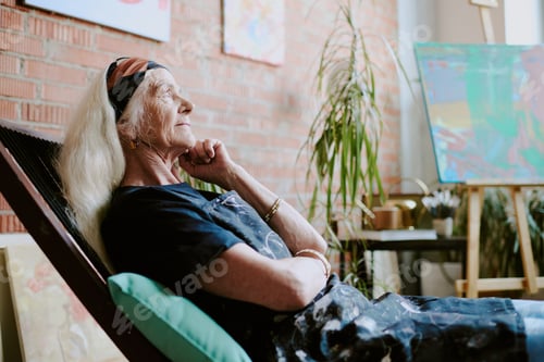 Preview: Senior Artist Relaxing On Chair In Studio