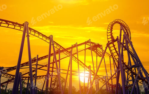 Preview: Roller coaster in the amusement park with the sunset background.