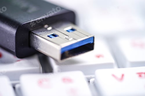 Preview: USB thumb external drive on white keyboard