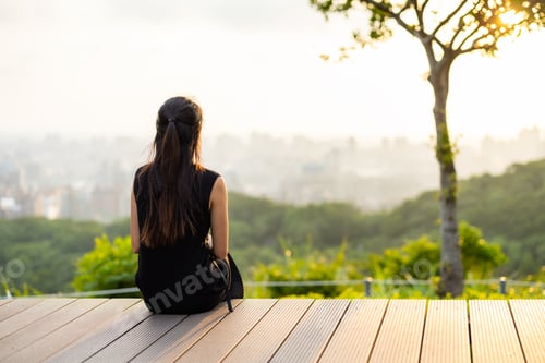 Preview: Woman sit and look at the sunset view