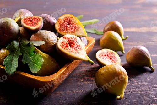 Preview: A close-up photo of fresh figs, some whole and some halved, displayed in a wooden bowl