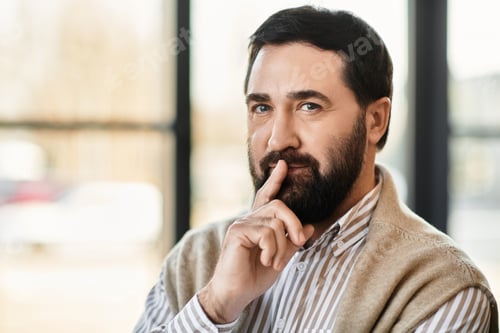 Preview: Charming elderly man with a thoughtful expression enjoying a quiet moment indoors