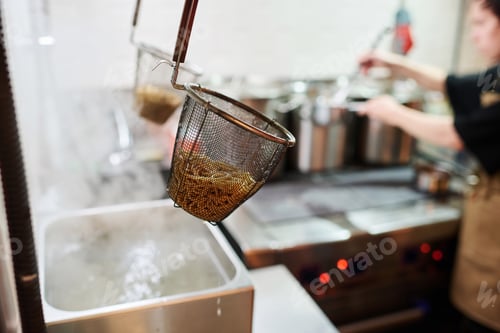 Preview: Boiled ramen in colander hanging over metallic sink in spacious kitchen