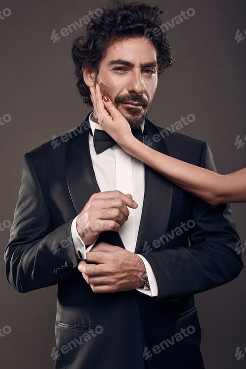 Preview: Fashionable Portrait Of Elegant Sexy Couple In Studio. Brutal Man In Suit With Woman'S Hand