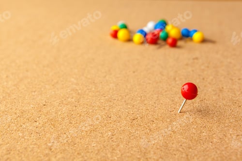 Preview: Group of colorful push pins on cork bulletin board