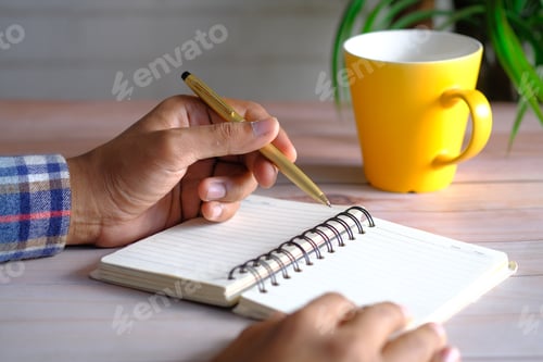Preview: Close up of man hand writing on notepad.