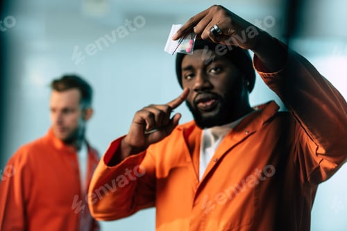 Preview: african american prisoner pointing on drugs at prison cell