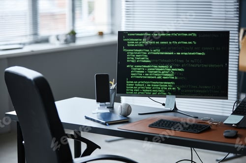 Preview: Modern Office Desk Featuring Smartphone and Baseball Beside Coding Monitor