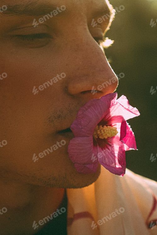 Preview: Man model face with flower in mouth. Art concept. Polaroid effect.