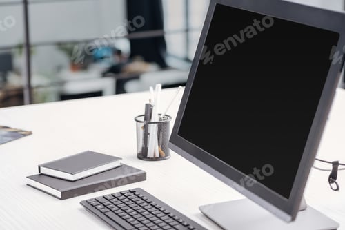 Preview: close up of computer monitor with blank screen and stationery at workplace