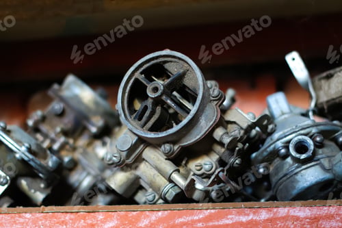 Preview: Old gasoline engine blurred background. real used car motor head engine four cylinder over garage ba