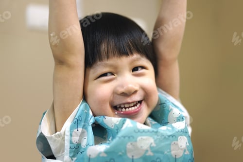 Preview: child hands up with smiling face.