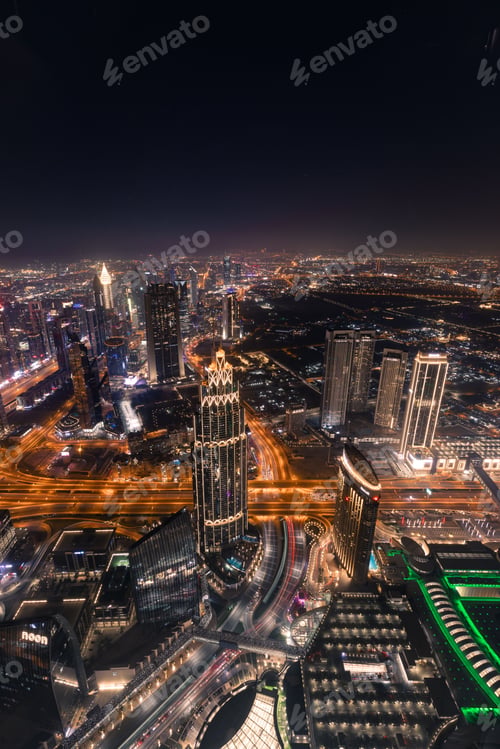 Preview: Vertical aerial view of Dubai downtown at night from the top of Burj Khalifa Tower, UAE
