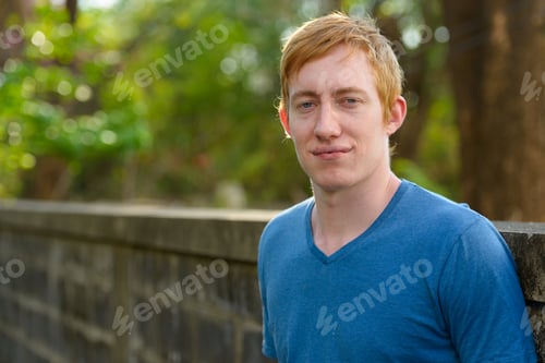 Preview: Face of man with red hair relaxing in the park