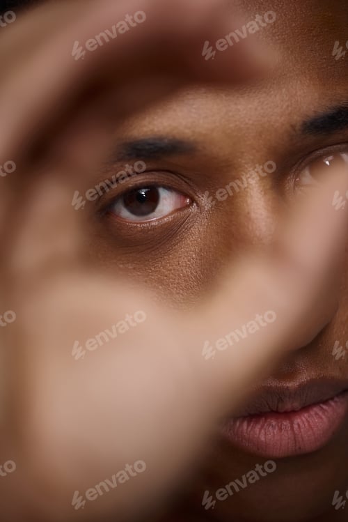 Preview: close up of handsome appealing african american man with hand in front of face, fashion concept