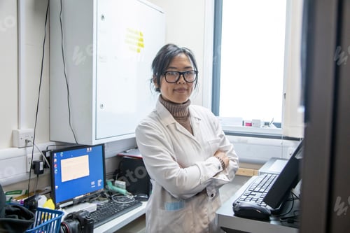 Preview: Scientist standing in a lab of a medical practice with computer equipment, UK