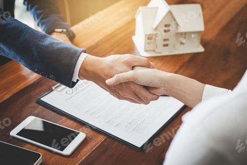Preview: Real estate agent and customers shaking hands together celebrating finished contract after about