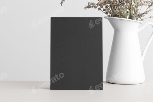 Preview: Black invitation card mockup with a dried lavender on a beige table. 5x7 ratio, similar to A6, A5.