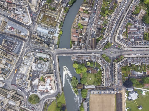 Preview: Aerial view of a beautiful cityscape with roads, buildings, cars, and river in Bath, UK