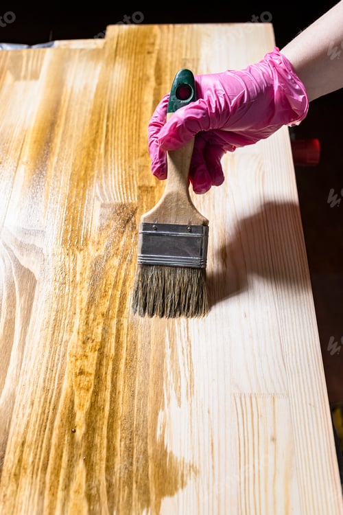Preview: solid board is hued with wood stain by paintbrush