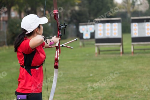 Preview: Female athlete practicing archery in stadium