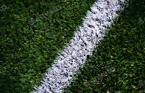 Preview: White stripe on a bright green artificial grass soccer field
