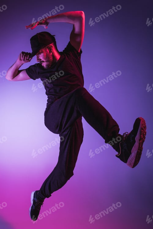 Preview: The silhouette of one hip hop male break dancer dancing on colorful background