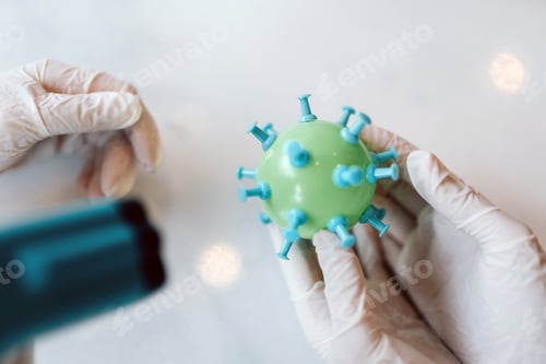 Preview: Scientist virologist holding model of new Coronavirus or COVID-19
