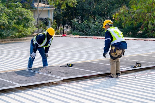 Preview: workers installing solar panels, for efficient energy on rooftop