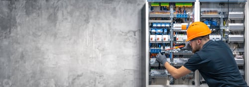 Preview: Electrician working in switchboard with electrical connection cable, copy space.