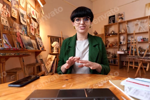 Preview: Smiling creative woman speaking to video chat